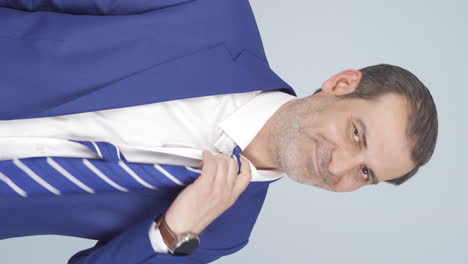 Vertical-video-of-Stressed-businessman-loosens-his-tie.